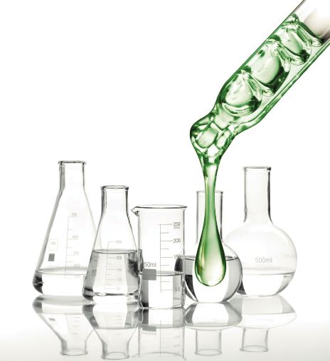 beakers and green polymer droplet